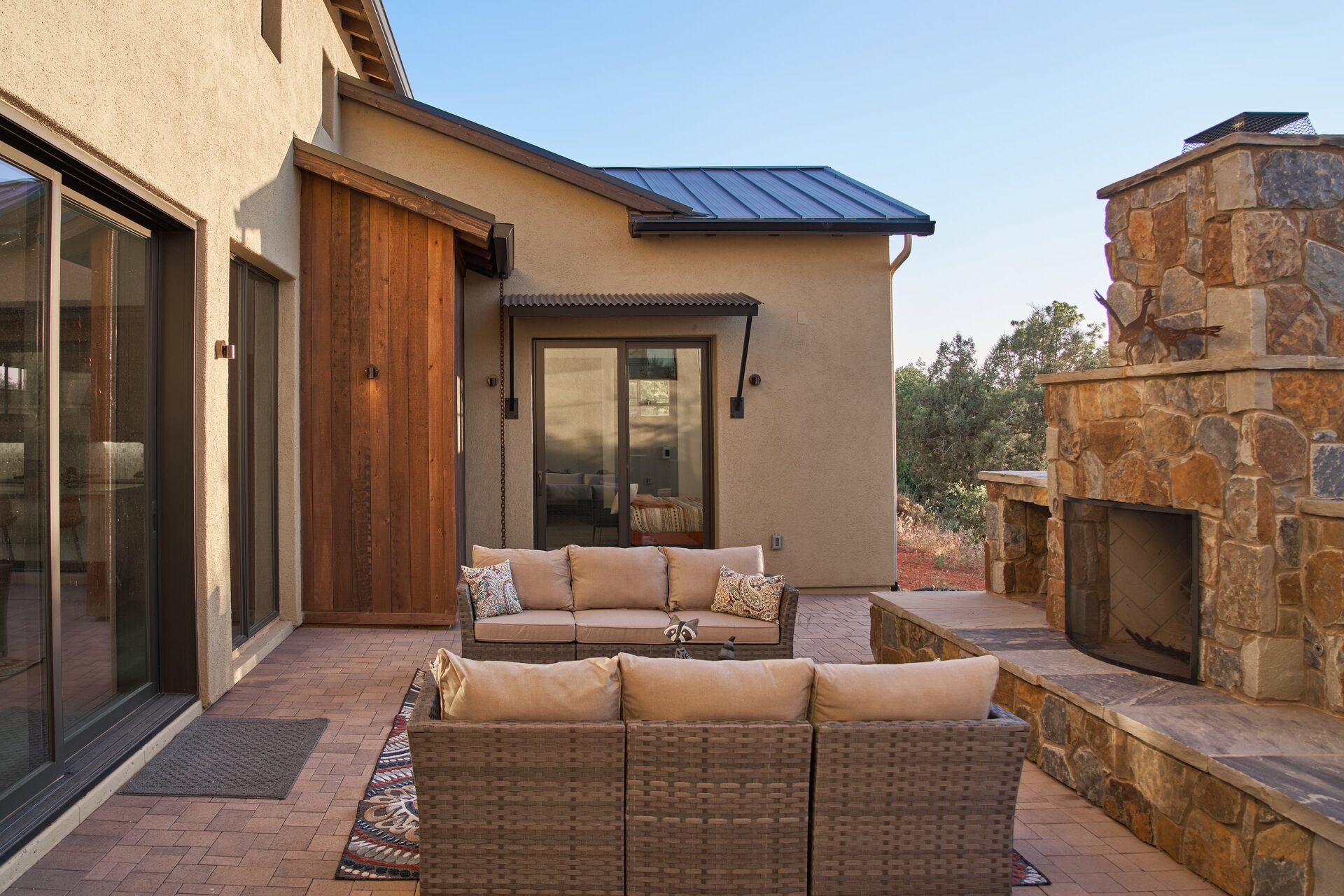 Covered outdoor terrace with stone fireplace